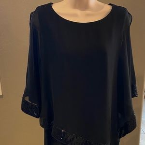 Black dress with sheer overlay with bottom of overlay having sequin